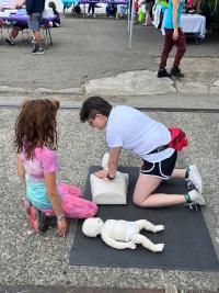 Two girls changing a diaper for a doll