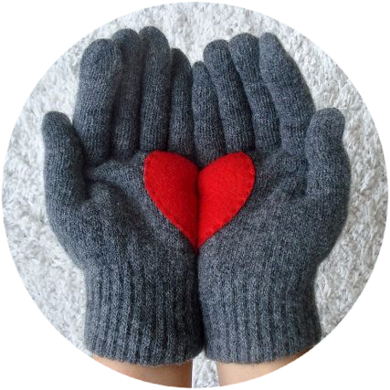 Gloved hands holding cloth heart