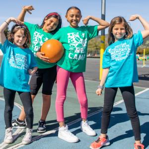 Y Camp children posing on basketball court