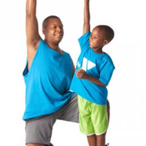 man and child lifting hand weights together